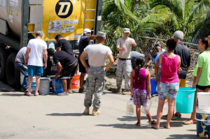 people gathering to obtain water from FEMA after hurricane maria