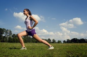 Woman doing lunges outside