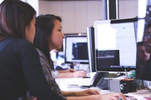 Two women working at a computer