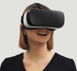 A woman looking through VR goggles