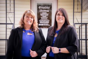 Linda Rawson and Jennifer Remund in front of the DynaGrace office