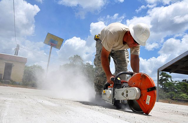 Master Sgt. Donnie Bogan saws cutting lines in concrete